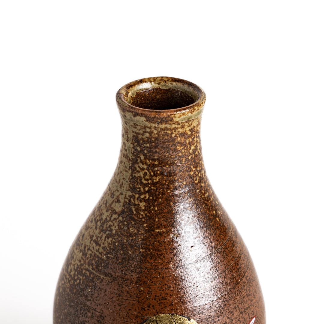 Brown ceramic sake carafe with a decorative rabbit and moon design, perfect for serving sake and adding a touch of traditional Japanese style to your table.