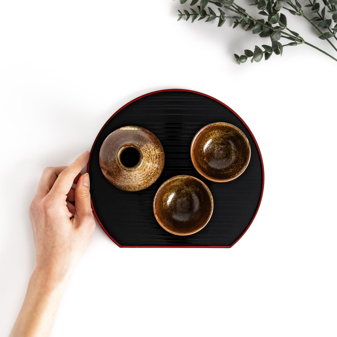 Brown ceramic sake set with a rabbit and moon design, including a sake carafe and two cups presented on a serving tray, perfect for enjoying sake with a friend.