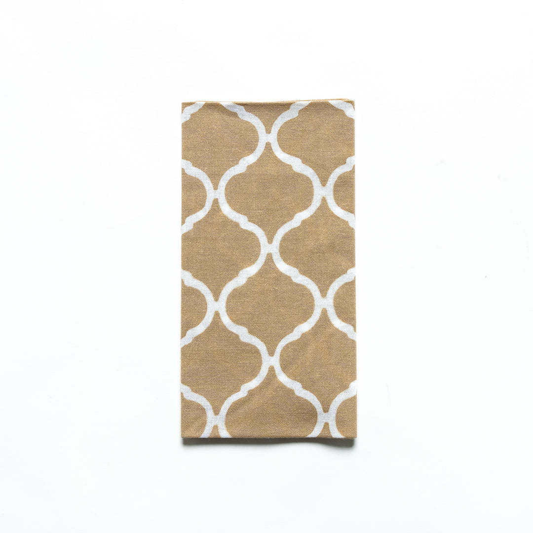 Close-up of the beige Moroccan tile hand towel folded with product sleeve attached.