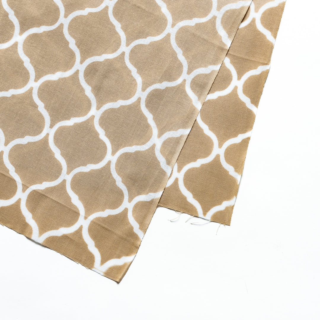 Close-up view of the elegant white lattice pattern on the beige tenugui hand towel.