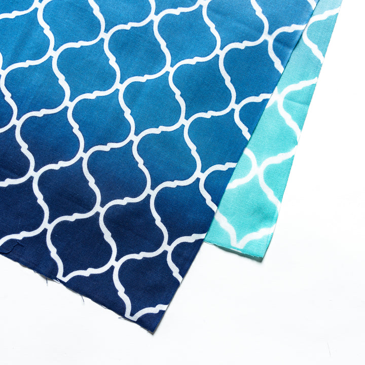 Close-up view of the intricate white lattice pattern on the blue tenugui hand towel.