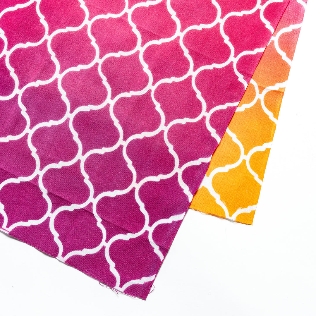 Close-up view of the white lattice pattern on the vibrant pink tenugui hand towel.