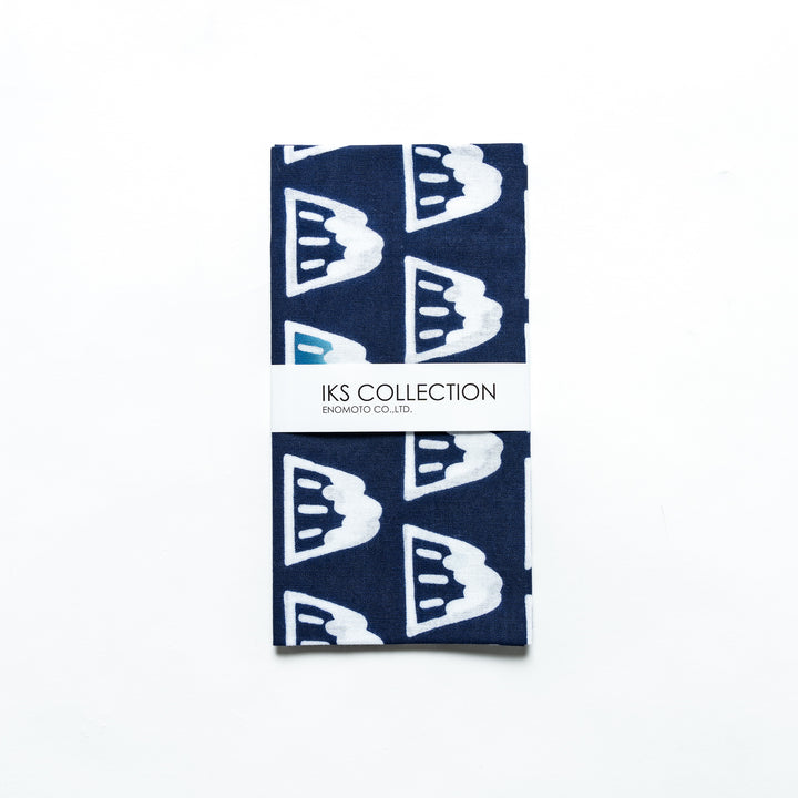 Folded navy blue tenugui with Mount Fuji motifs, elegantly wrapped in a product sleeve.