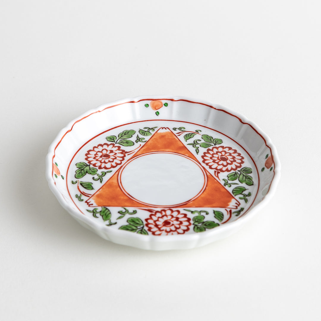 Porcelain plate with a floral and geometric pattern, captured at a slight angle to emphasize depth and design.