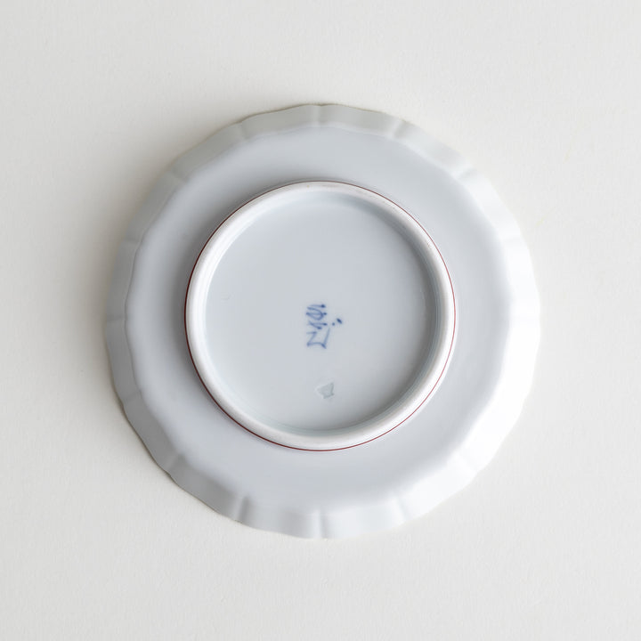 Bottom view of the porcelain plate, showcasing its smooth surface and base design.