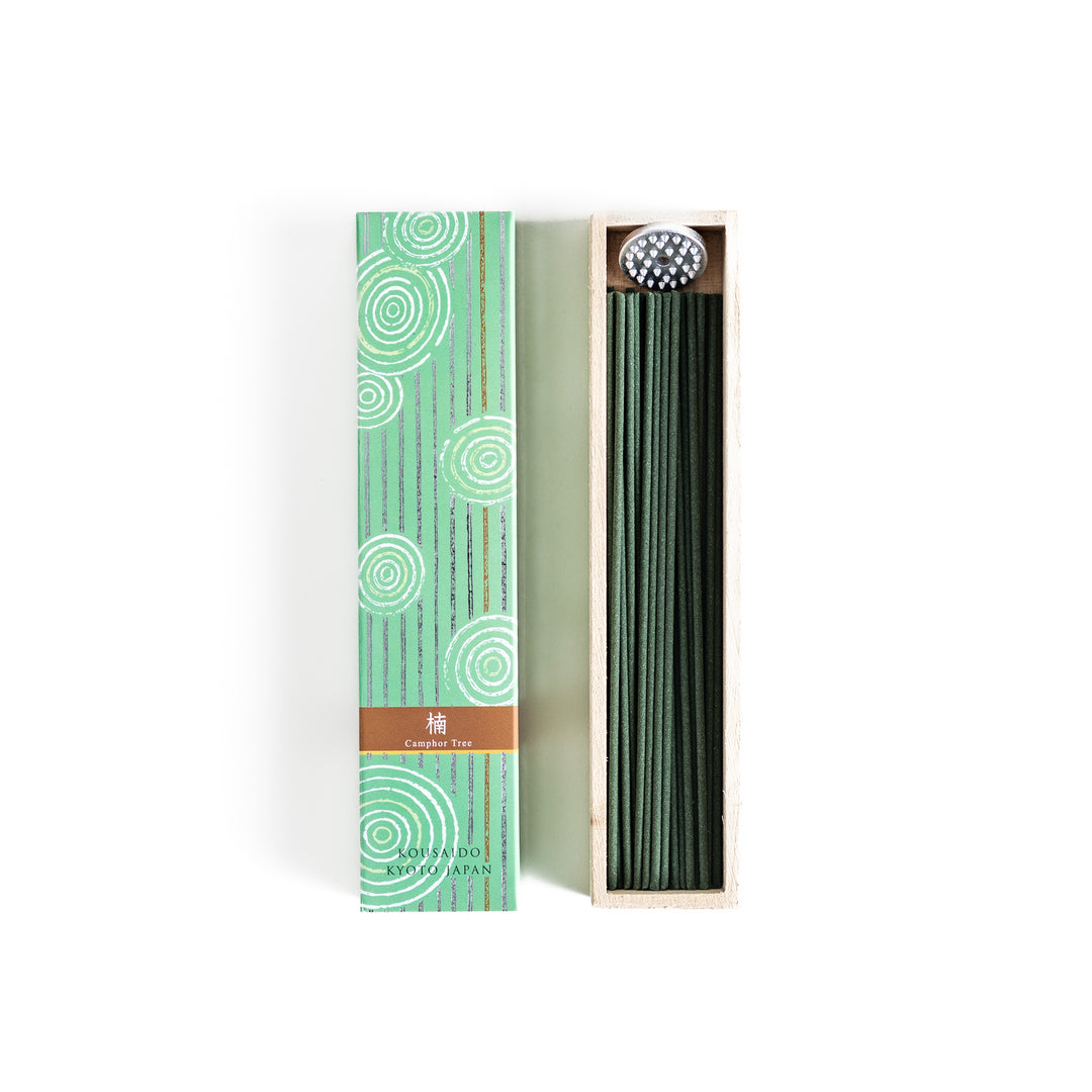 Mystic Camphor Incense in a light wooden box with deep green sticks, elegantly packaged in a soft green design featuring white circular patterns, evoking a refreshing and invigorating camphor aroma.