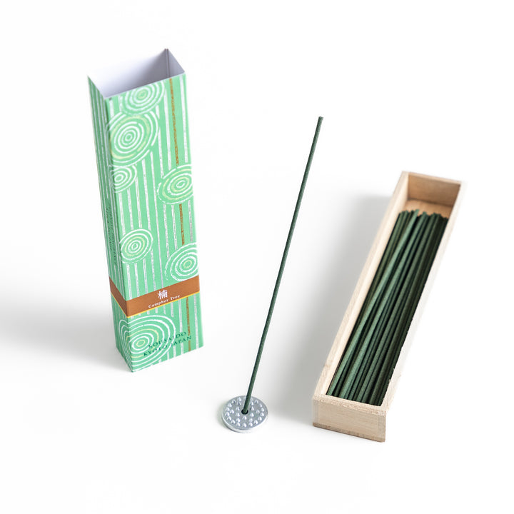 Mystic Camphor Incense in a light wooden box with deep green sticks, elegantly packaged in a soft green design featuring white circular patterns, evoking a refreshing and invigorating camphor aroma.