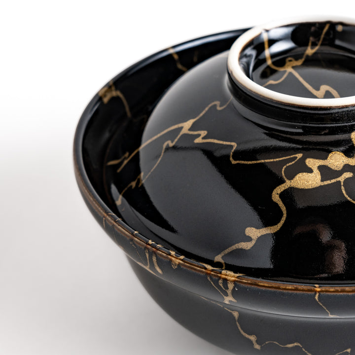 Black ceramic donburi bowl with a striking gold marbled design and a matching lid, perfect for serving and enjoying a variety of Japanese rice dishes."