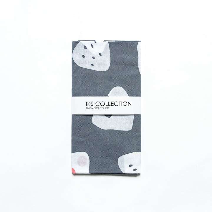 Gray tenugui neatly folded with product sleeve, featuring charming rice ball designs.