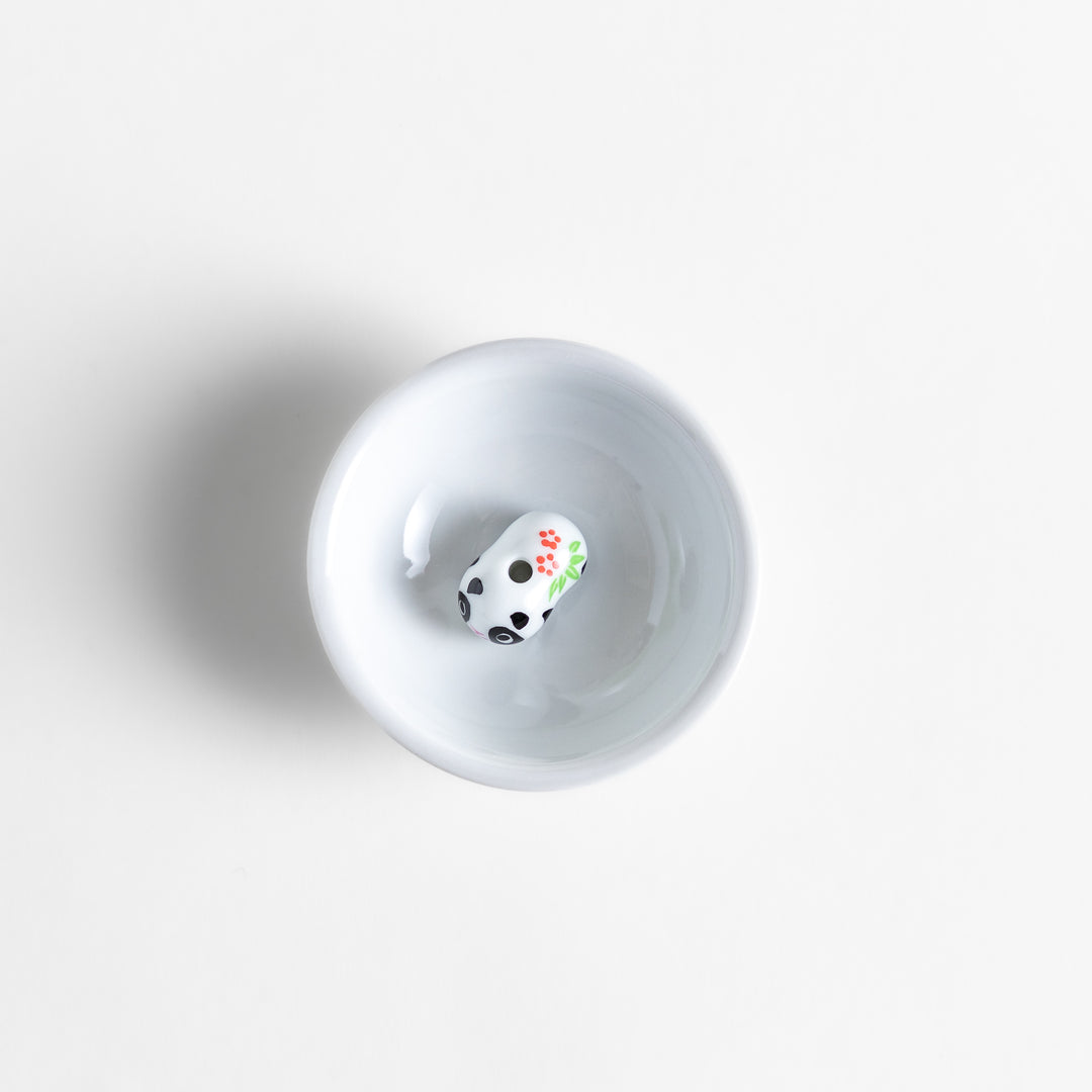 White ceramic incense holder featuring an adorable panda-shaped holder with floral accents, offering a charming and playful touch to incense rituals and home decor.