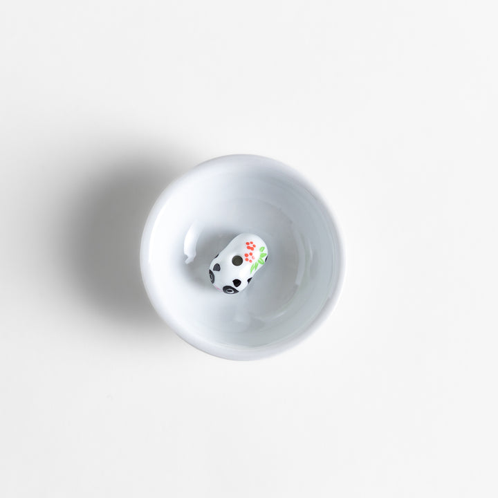 White ceramic incense holder featuring an adorable panda-shaped holder with floral accents, offering a charming and playful touch to incense rituals and home decor.