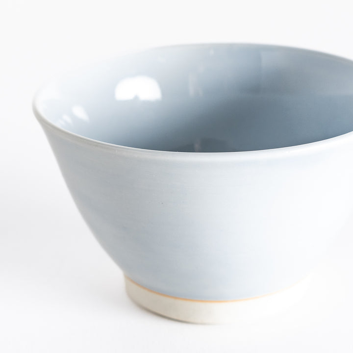 Close-up of a light blue dessert bowl, showing its smooth ceramic texture and calming pastel shade.