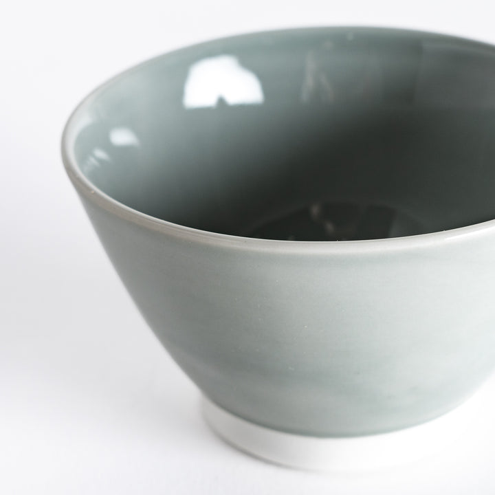 Close-up of a pastel gray dessert bowl, focusing on its refined ceramic texture and muted pastel finish.