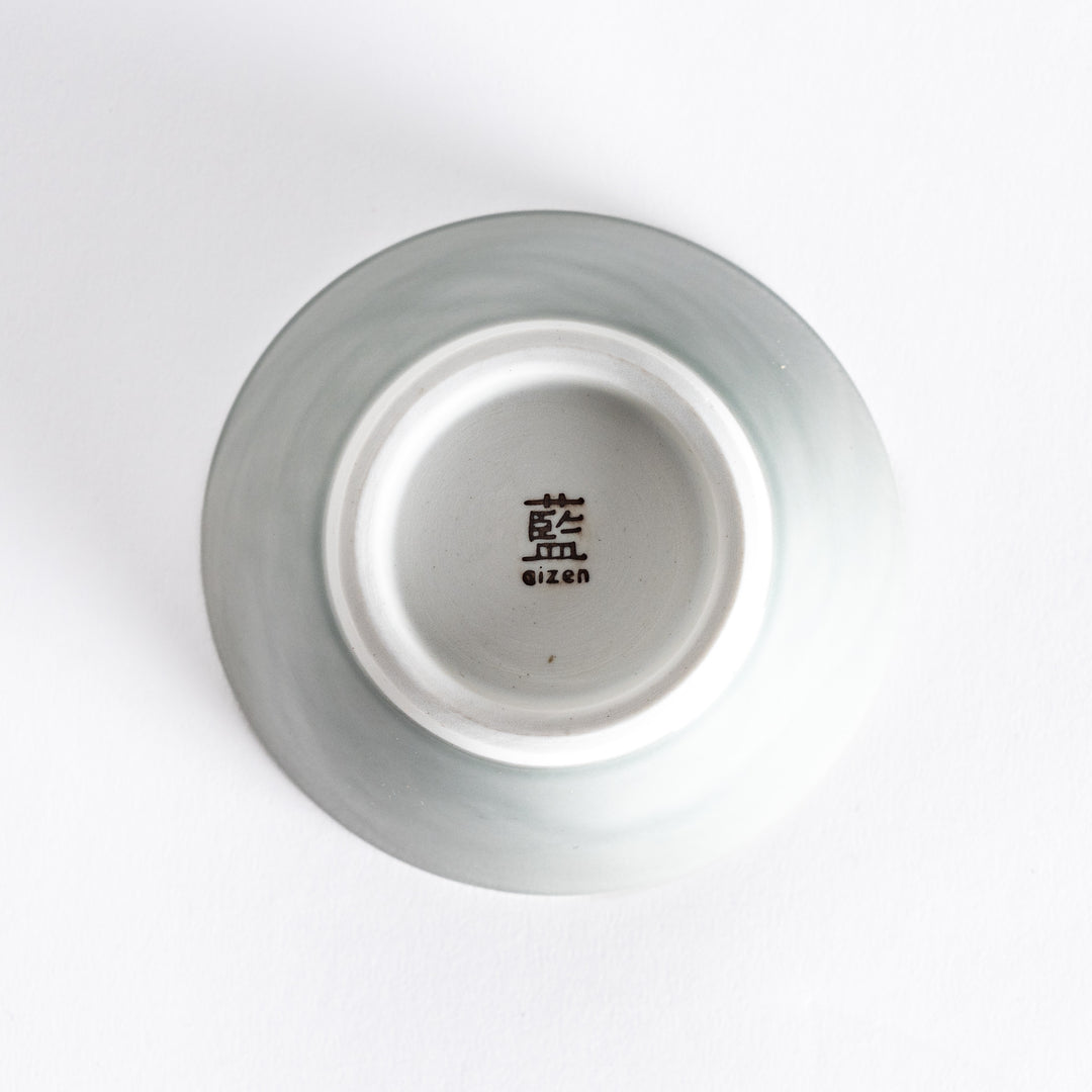 Bottom view of a pastel gray dessert bowl, featuring a clean white base and minimalist design.