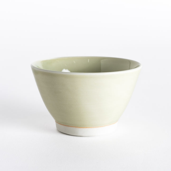 Light green dessert bowl, viewed from the front, with a smooth surface and soft pastel shade.