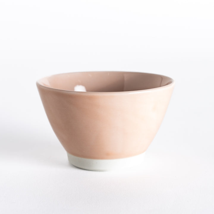 Soft pink dessert bowl, viewed from the front, highlighting its smooth surface and elegant curves.