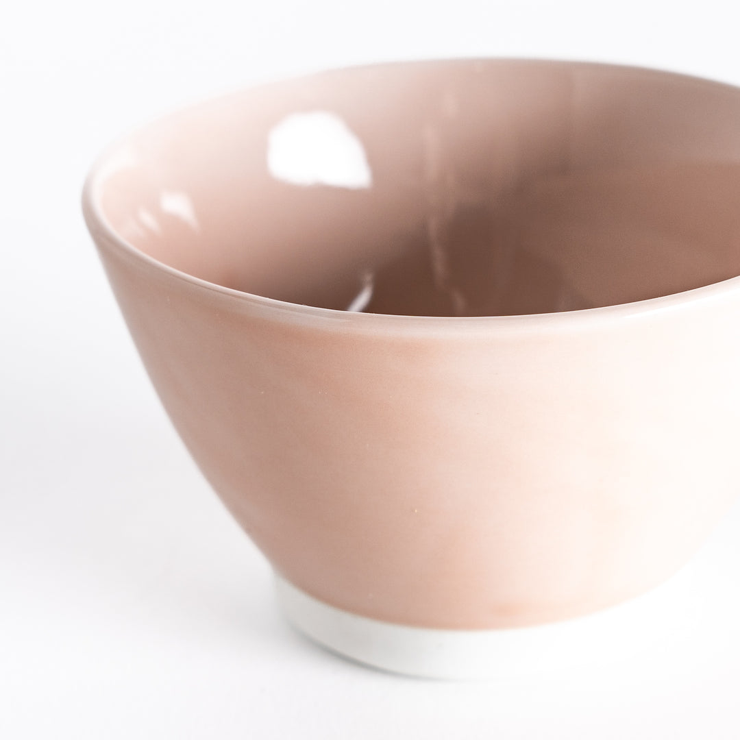 Close-up of a soft pink dessert bowl, focusing on its smooth ceramic texture and delicate pastel hue.