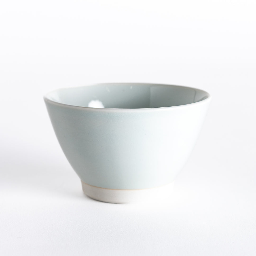 Blue-tinted white dessert bowl, viewed from the front, emphasizing its subtle hue and smooth finish.