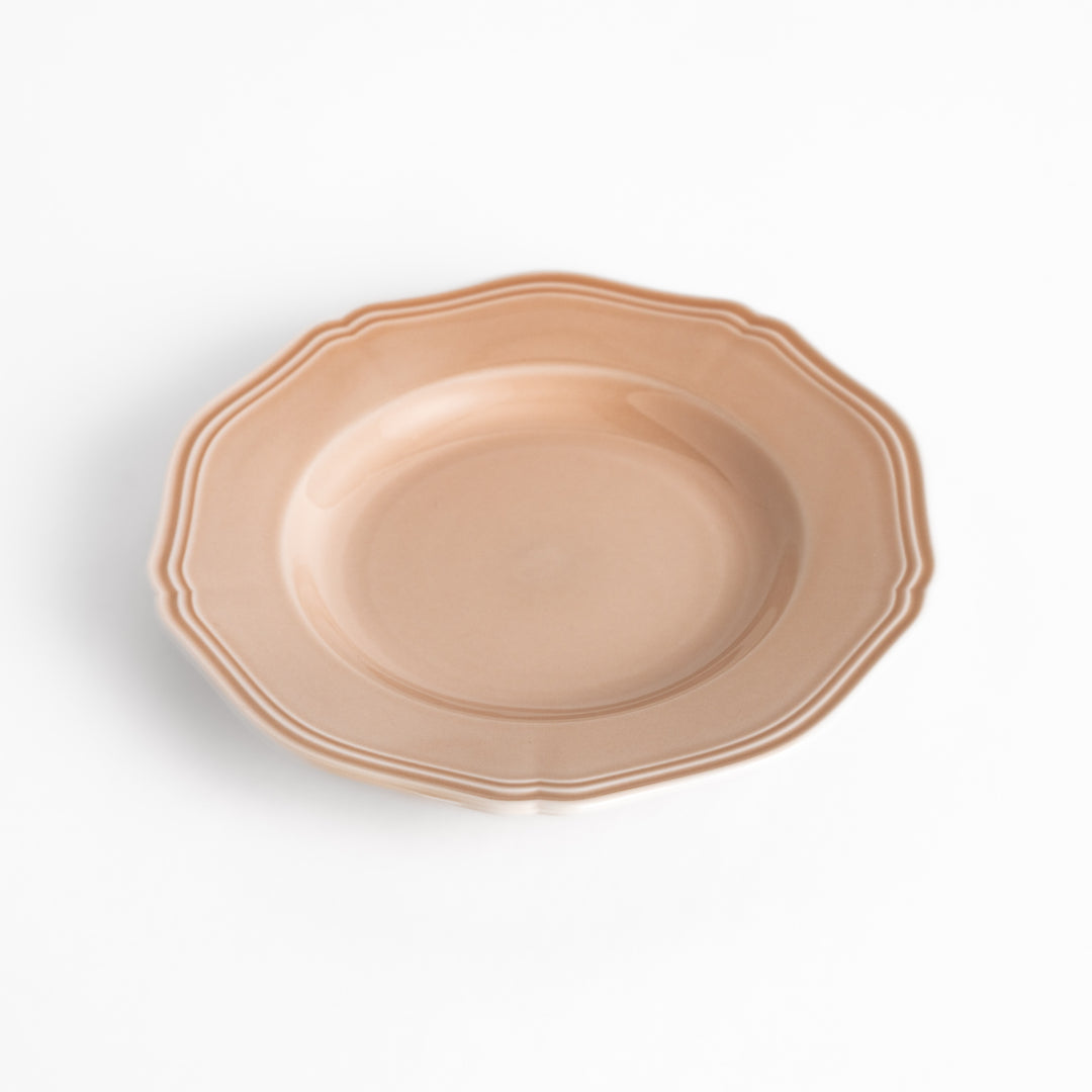 Pretty pink dessert plate with a delicate scalloped edge, ideal for showcasing your favorite treats.