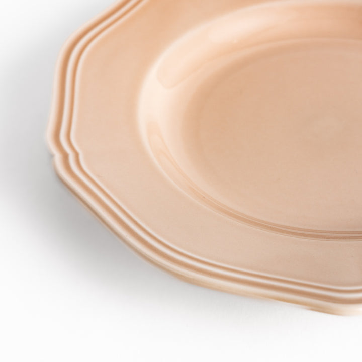 Pretty pink dessert plate with a delicate scalloped edge, ideal for showcasing your favorite treats.