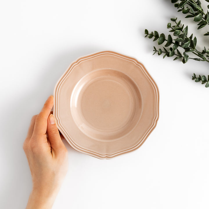 Pretty pink dessert plate with a delicate scalloped edge, ideal for showcasing your favorite treats.