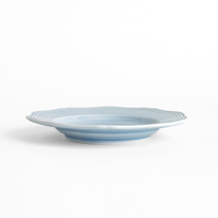 Pretty blue dessert plate with a delicate scalloped edge, ideal for showcasing your favorite treats.