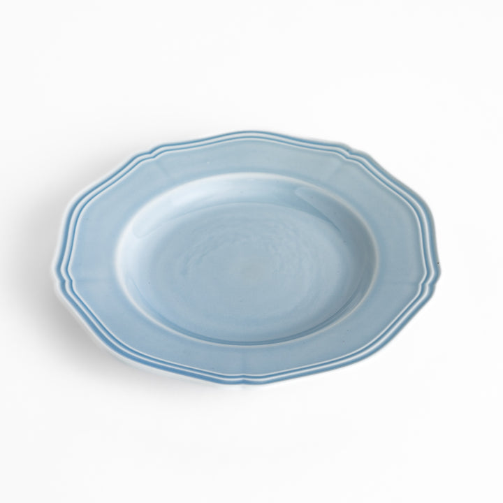 Pretty blue dessert plate with a delicate scalloped edge, ideal for showcasing your favorite treats.