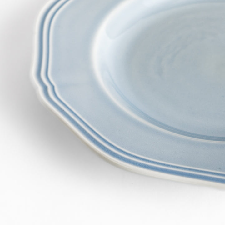 Pretty blue dessert plate with a delicate scalloped edge, ideal for showcasing your favorite treats.