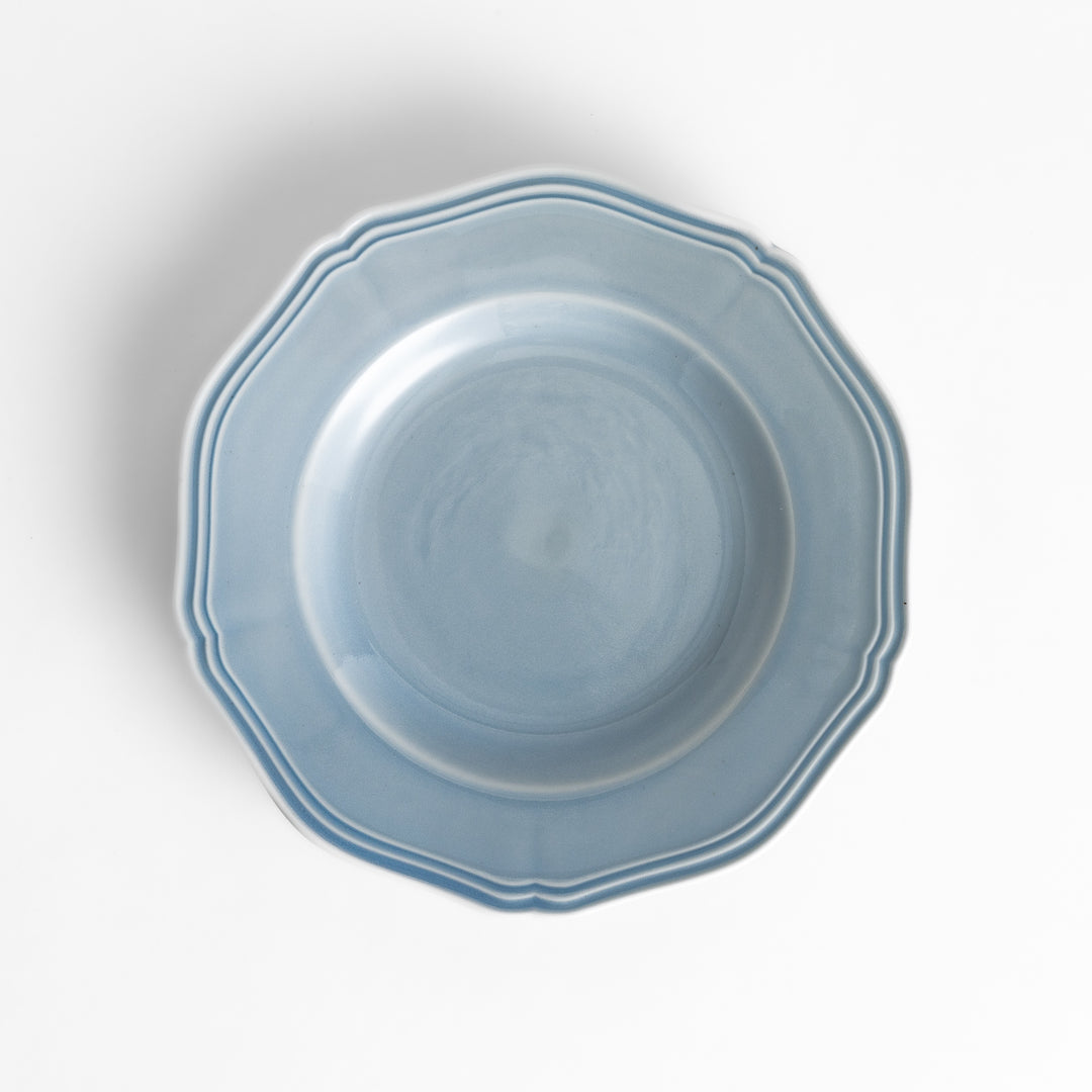 Pretty blue dessert plate with a delicate scalloped edge, ideal for showcasing your favorite treats.