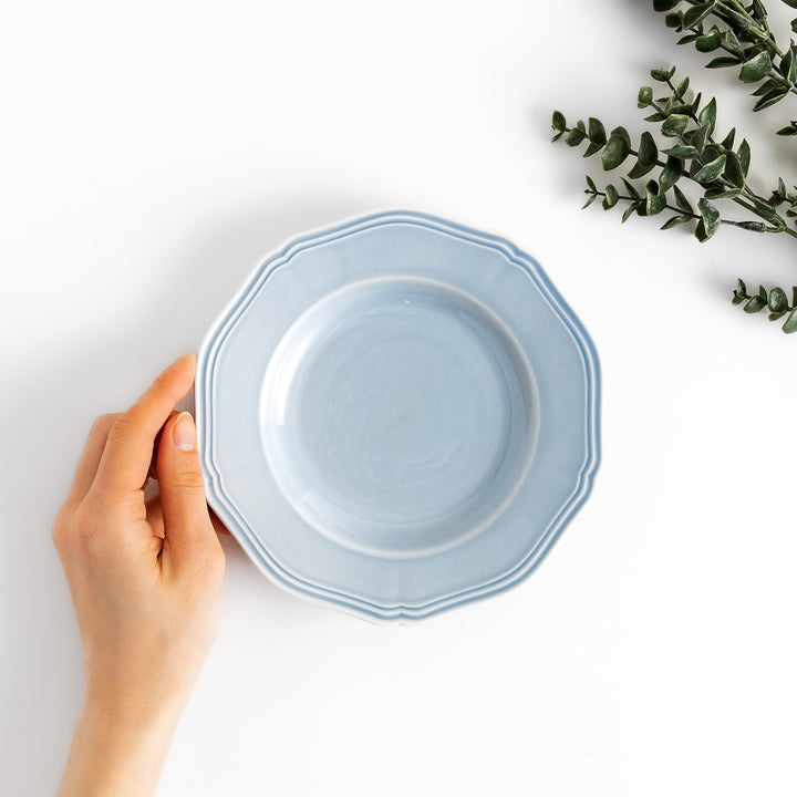 Pretty blue dessert plate with a delicate scalloped edge, ideal for showcasing your favorite treats.