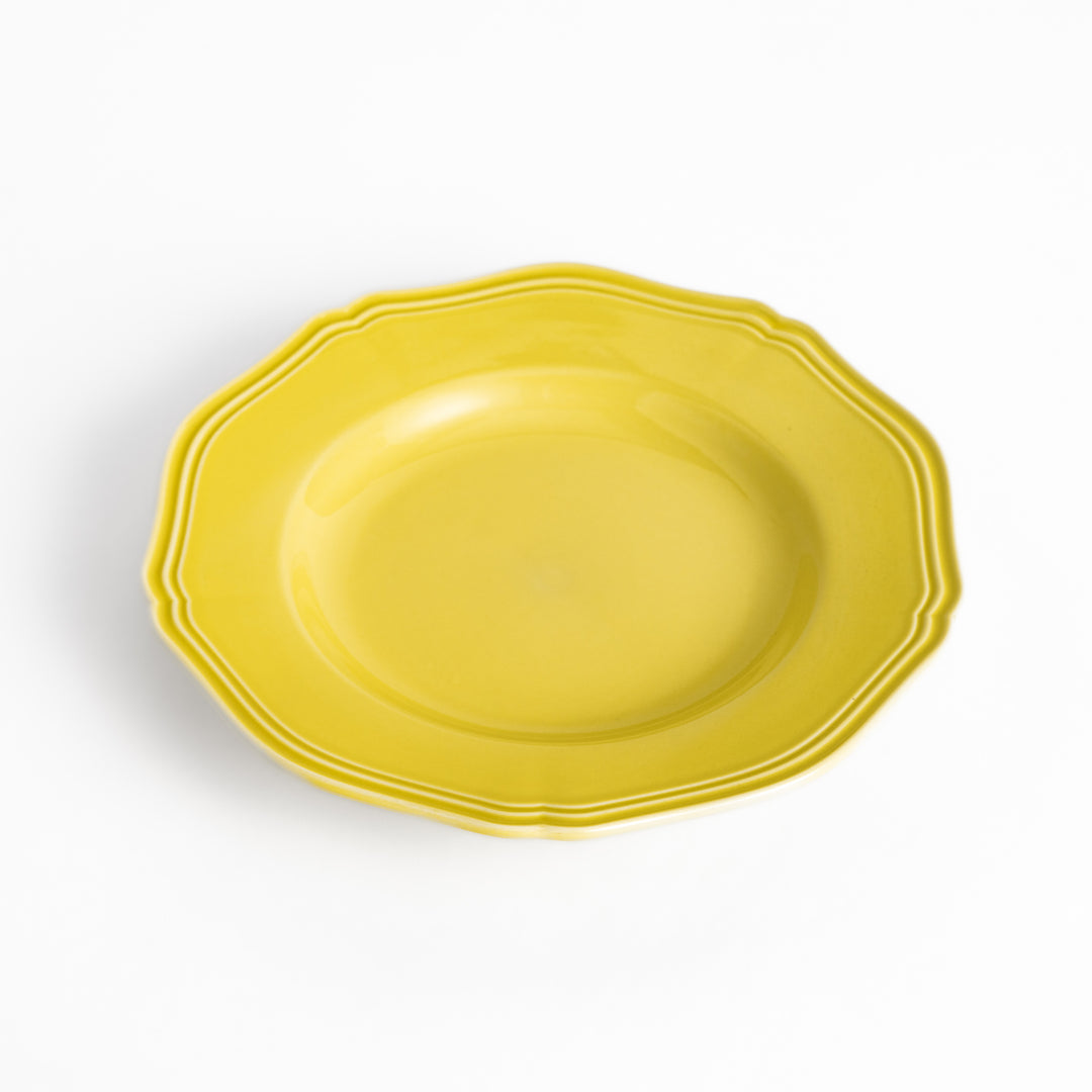 Pretty yellow dessert plate with a delicate scalloped edge, ideal for showcasing your favorite treats.