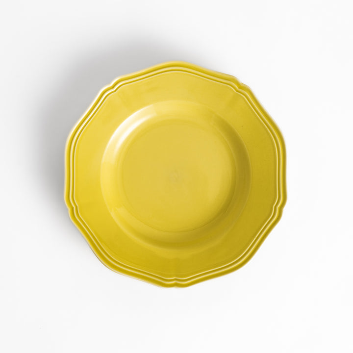 Pretty yellow dessert plate with a delicate scalloped edge, ideal for showcasing your favorite treats.