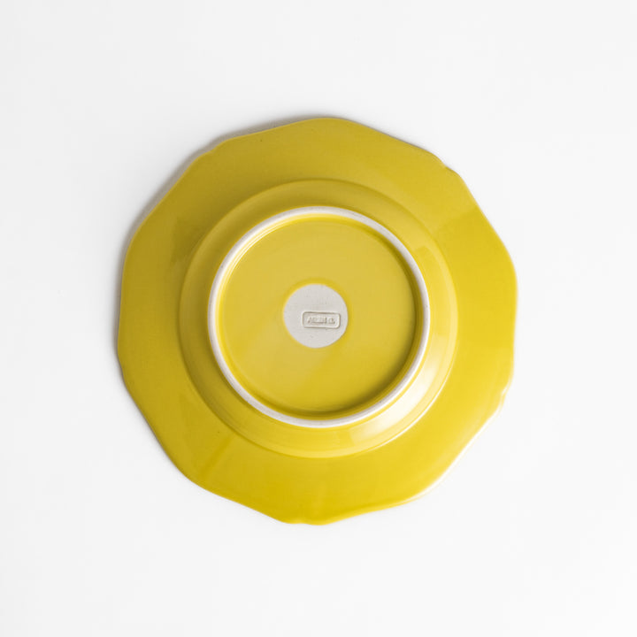 Pretty yellow dessert plate with a delicate scalloped edge, ideal for showcasing your favorite treats.