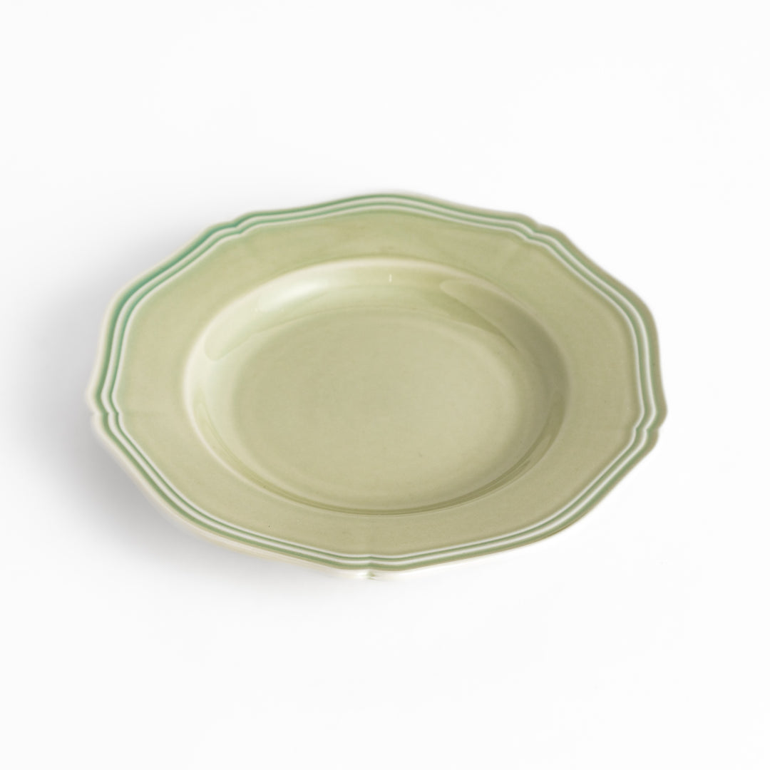 Pretty green dessert plate with a delicate scalloped edge, ideal for showcasing your favorite treats.