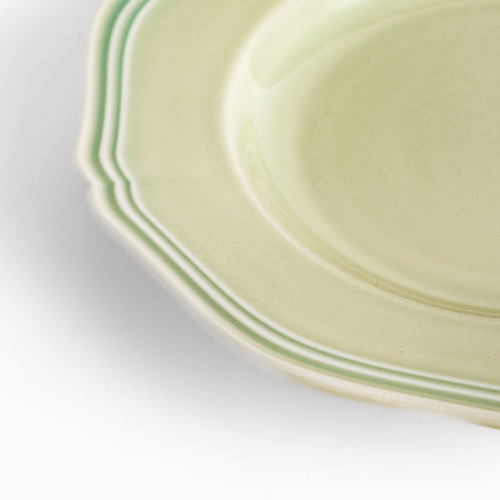 Pretty green dessert plate with a delicate scalloped edge, ideal for showcasing your favorite treats.