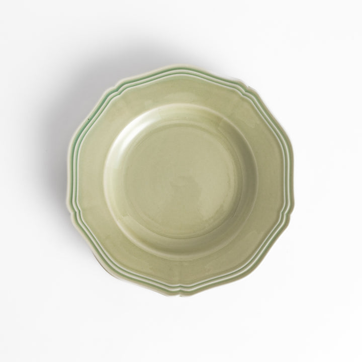 Pretty green dessert plate with a delicate scalloped edge, ideal for showcasing your favorite treats.