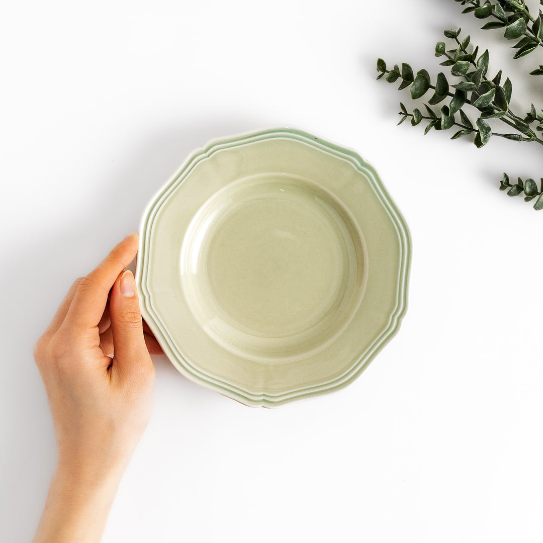 Pretty green dessert plate with a delicate scalloped edge, ideal for showcasing your favorite treats.