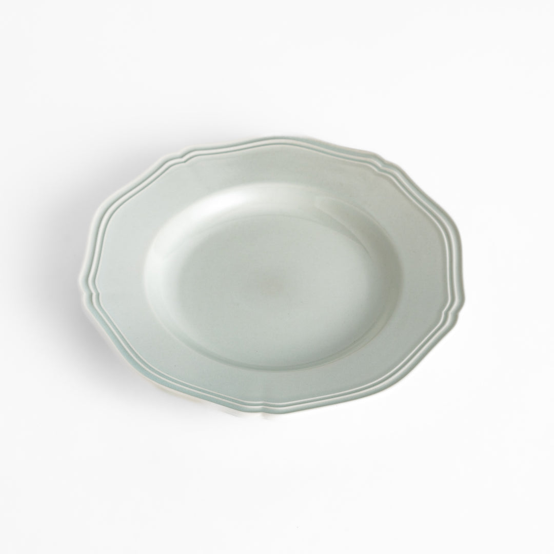 Pretty white dessert plate with a delicate scalloped edge, ideal for showcasing your favorite treats.