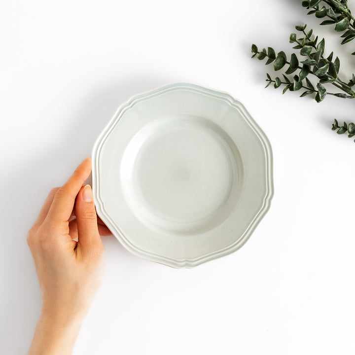 Pretty white dessert plate with a delicate scalloped edge, ideal for showcasing your favorite treats.