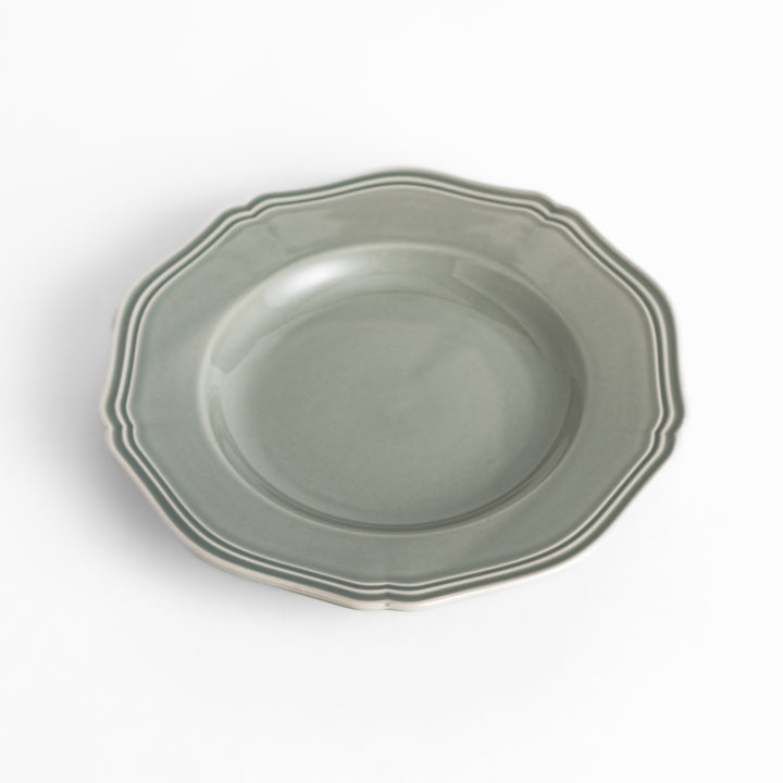 Pretty gray dessert plate with a delicate scalloped edge, ideal for showcasing your favorite treats.