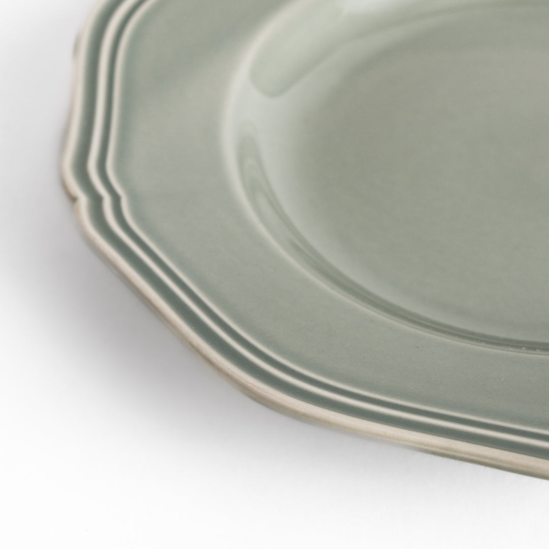 Pretty gray dessert plate with a delicate scalloped edge, ideal for showcasing your favorite treats.