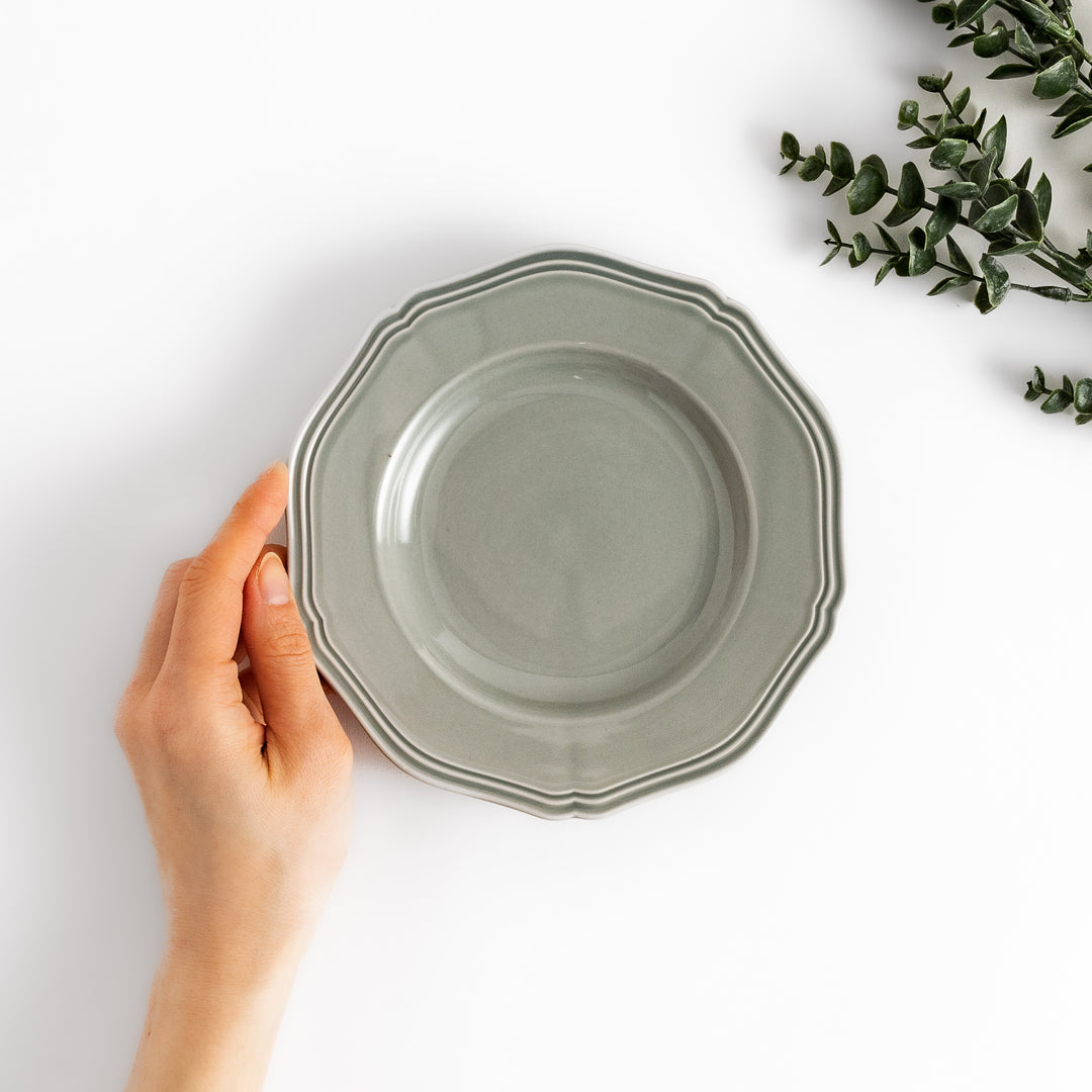 Pretty gray dessert plate with a delicate scalloped edge, ideal for showcasing your favorite treats.