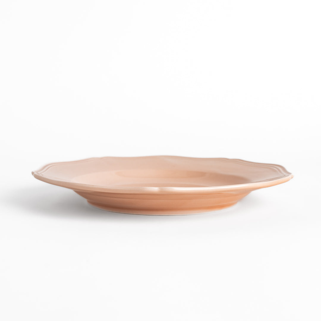 Pretty pink dinner plate with a delicate scalloped edge, ideal for showcasing your culinary creations.