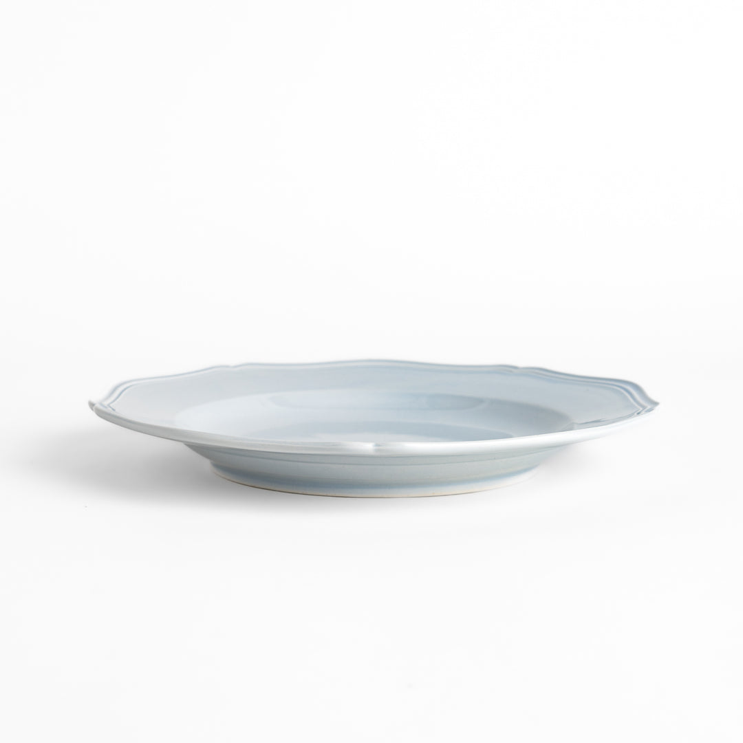 Pretty blue dinner plate with a delicate scalloped edge, ideal for showcasing your culinary creations.