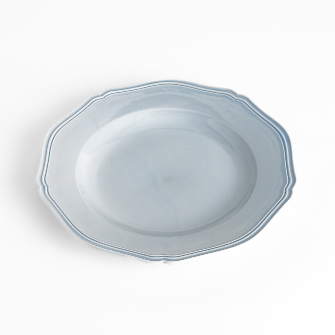 Pretty blue dinner plate with a delicate scalloped edge, ideal for showcasing your culinary creations.