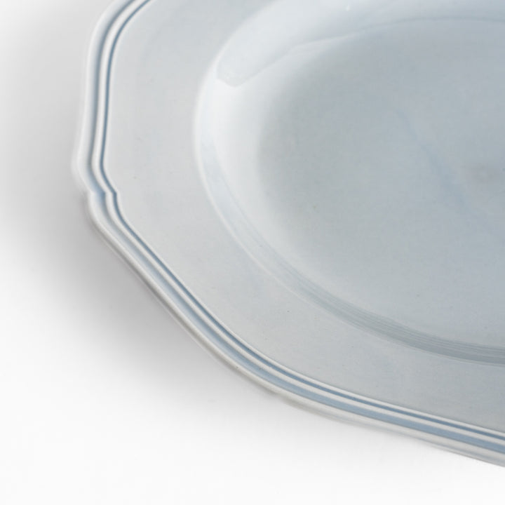 Pretty blue dinner plate with a delicate scalloped edge, ideal for showcasing your culinary creations.