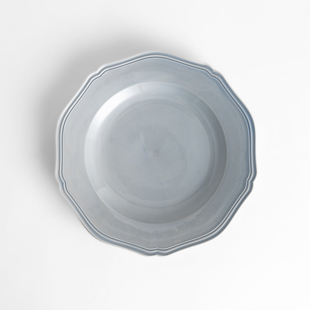 Pretty blue dinner plate with a delicate scalloped edge, ideal for showcasing your culinary creations.