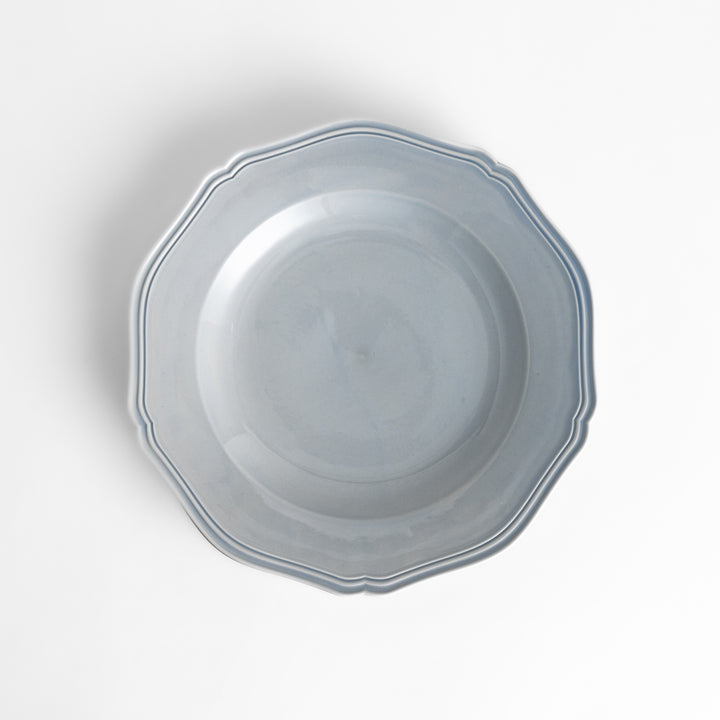 Pretty blue dinner plate with a delicate scalloped edge, ideal for showcasing your culinary creations.