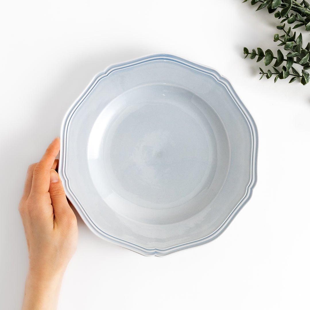 Pretty blue dinner plate with a delicate scalloped edge, ideal for showcasing your culinary creations.