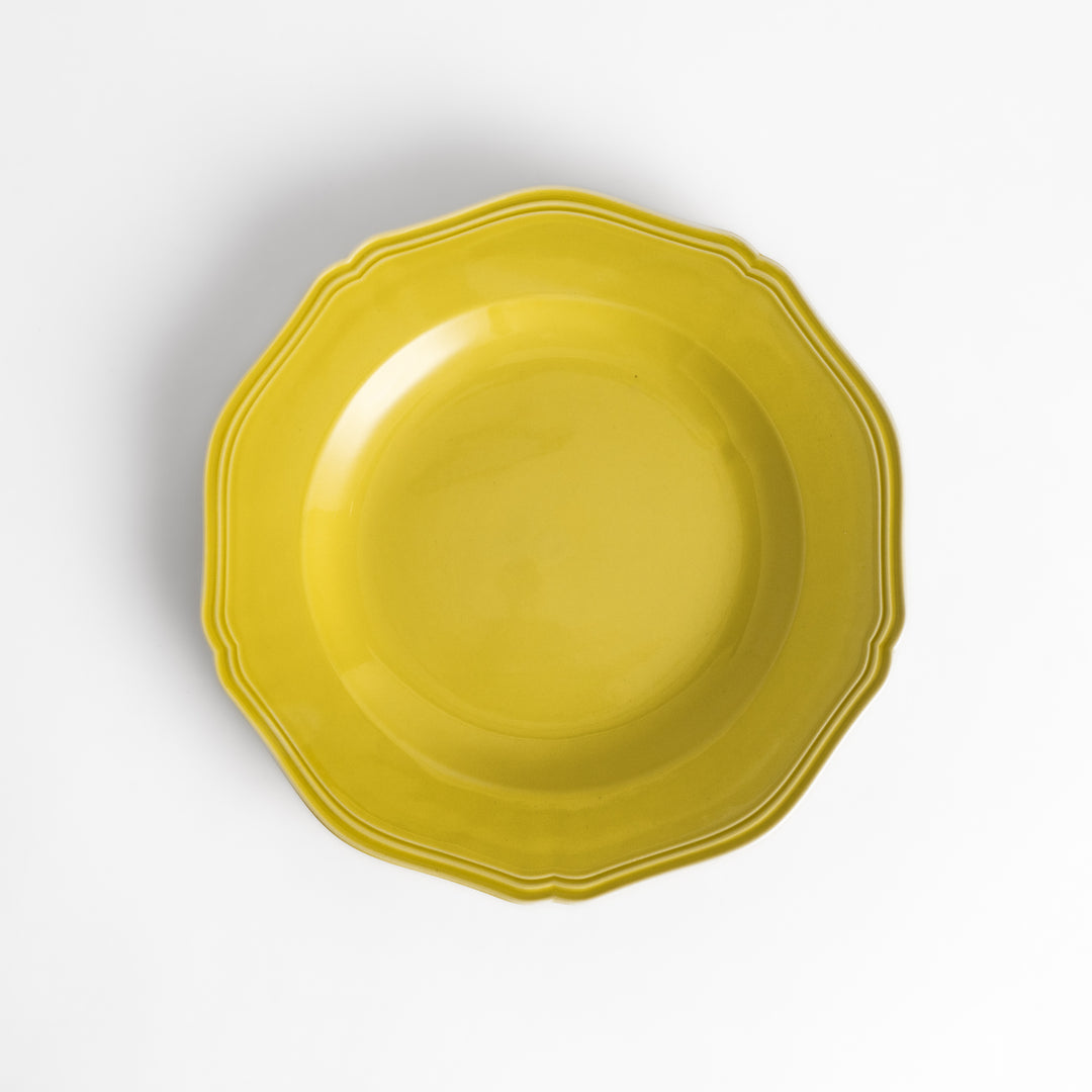 Pretty yellow dinner plate with a delicate scalloped edge, ideal for showcasing your culinary creations.